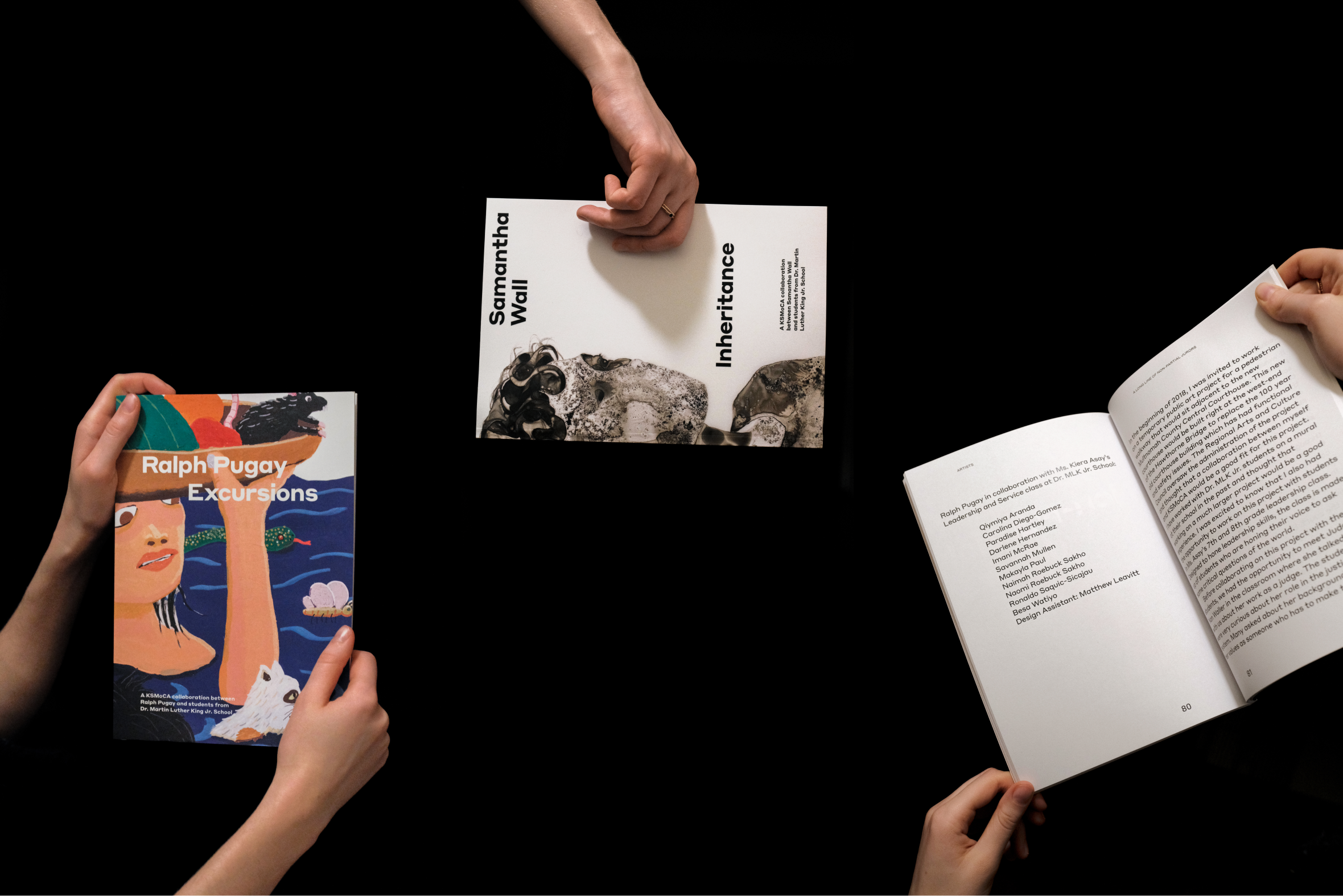 photograph with two artist catalog covers and interor spread